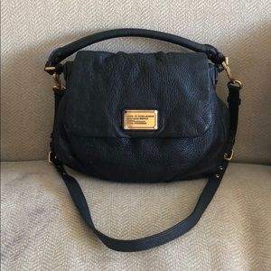 Black leather Marc Jacobs handbag with strap.